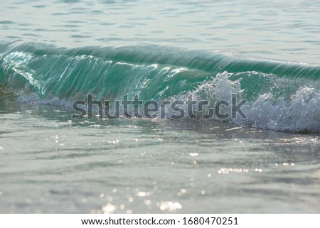 Sea tide splashes, turbulent water closeup. Surface of the sea waves, splash, foam and bubbles at high tide and surf, aqua abstract background