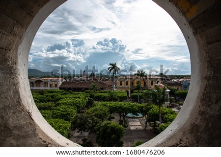 Granada Nicaragua plaza main square with view on central Park of granada from church steeple round Window historical cathedral beautiful Old town Central America culture Royalty-Free Stock Photo #1680476206
