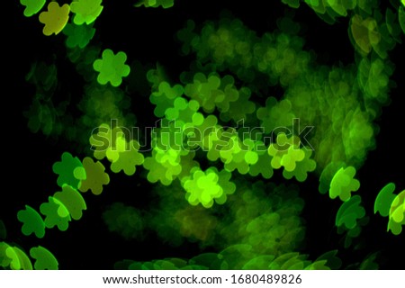 flower background green red blue bokeh lens effect six leaves dark black background with special camera lens filter