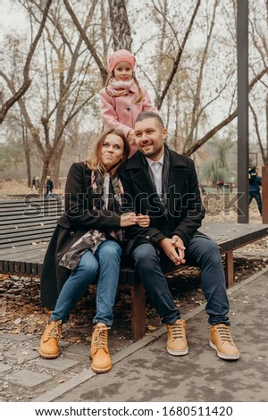 Happy fun family. Mother, father and daughter in the park