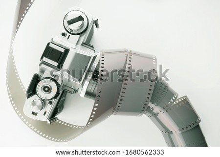 Film slr camera and a roll of negative film. Film camera and negative film. 