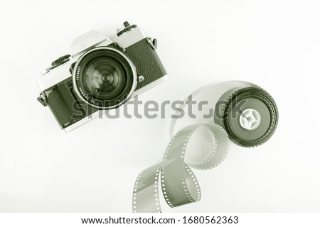 Film slr camera and a roll of negative film. Film camera and negative film. 