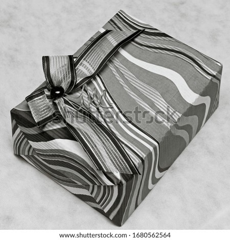 Modern silver gift box with decorative bow