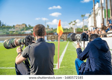 sports photographers and journalists recorded during the game on the football field