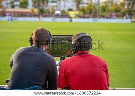 commentators on football game watching match. stream for television and radio Royalty-Free Stock Photo #1680572224