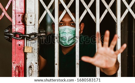 Stay at home or Quarantined man.Coronavirus covid-19 infected patient in coronavirus covid 19 quarantine home.Asian man quarantine 15 day lockdown at home.coronavirus outbreak control.Stop and control Royalty-Free Stock Photo #1680583171