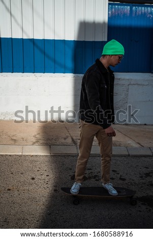 Portrait guy with a skateboard. Modern skater concept