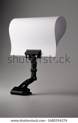 Empty  white paper with black stand