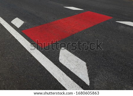 Newly constructed roads marked, with white lines and red stripes and arrows, rural Thailand