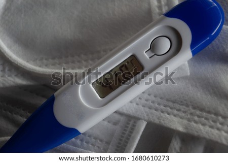 Digital thermometer on medical masks. 