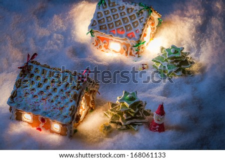 Snowy gingerbread cottage with santa and gifts