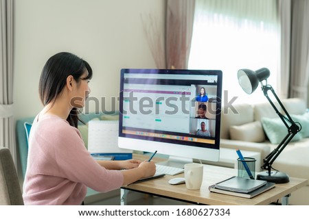 Asian business woman talking to her colleagues about plan in video conference. Multiethnic business team using computer for a online meeting in video call. Group of people smart working from home.
 Royalty-Free Stock Photo #1680627334