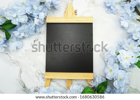 Empty Easel Space copy for text with Blooming flowers on marble background