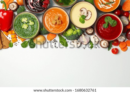 Vegetable soups and ingredients on white background, space for text