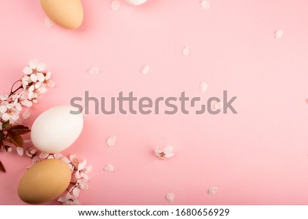 Easter time. Pink and white flowers of the sakura decorate the Easter composition.Easter spring floral pink background. Spring Religious holiday Easter.