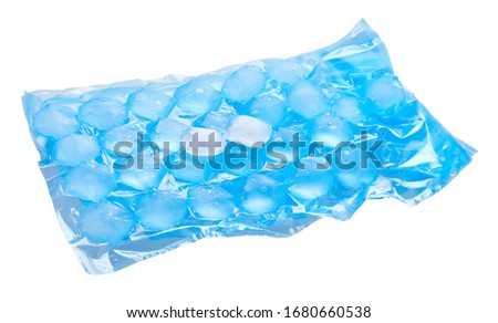Blue plastic packaging ice bags for home water freezing. Ice cubes in plastic bag,  freezer for ice circle cubes isolated on white with clipping path Royalty-Free Stock Photo #1680660538