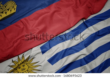 waving colorful flag of uruguay and national flag of liechtenstein. macro