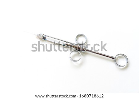 Dental instruments on a white background, syringe.
