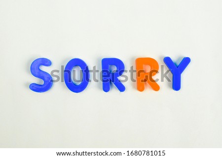 Sorry written in different colored letter blocks on an isolated white background