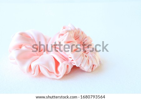 Pink silk Scrunchy isolated on white background. Flat lay Hairdressing tool of Colorful Elastic Hair Band, Bobble Scrunchie Hairband Royalty-Free Stock Photo #1680793564
