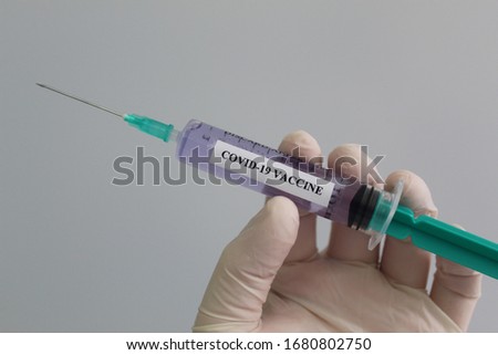 Microbiologist holding covid-19 sars-cov-2 coronavirus vaccine Royalty-Free Stock Photo #1680802750