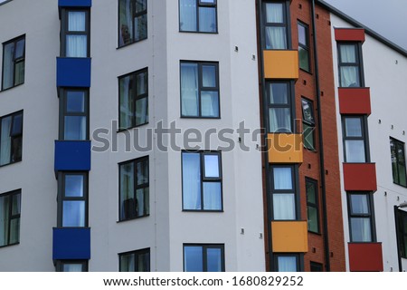 Close up of red, yellow and blue window panels from student accommodation. Colored windows from England. Royalty-Free Stock Photo #1680829252