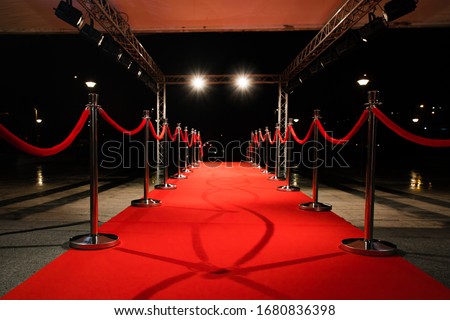 Red carpet with barriers and red ropes. Royalty-Free Stock Photo #1680836398
