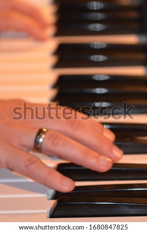 Piano keys with two playing hands