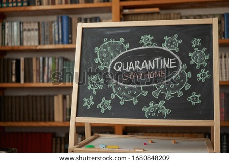 Quarantine. Outbreak Warning. written white chalk on blackboard in connection with epidemic of coronavirus worldwide. Covid 19 pandemic Text on black background with free space. drawn virus bacteria