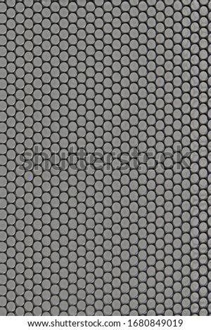 Metal background with round holes perforation, net of circles texture