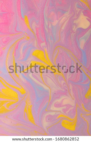 Abstract background of mixed shades of nail polish with marbled blur and sparkles. Liquid colorful paint background creative watercolor: pink, blue, beige, cream