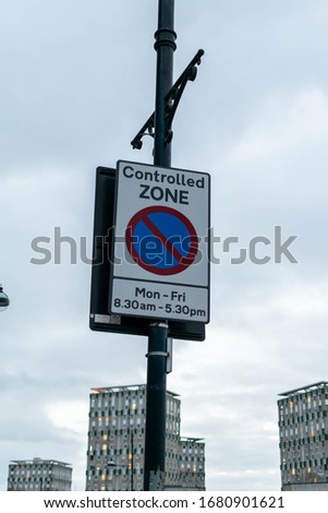 Controlled zone sign shown on street lamp post in the city centre in East London. This is to control parking restrictions in busy cities.