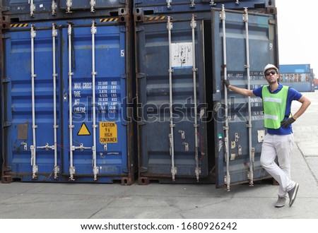 Worker inspecting cargo shipping containers. before departure.