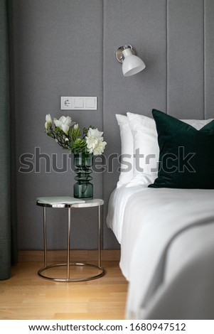 Small bright studio interior with bedroom area and set dining table