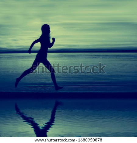 Silhouette of woman jogger running on sunset beach with reflection. girl jogging on sea beach at sunset. female jogging along ocean shore during sunrise. exercising outdoor. Healthy lifestyle