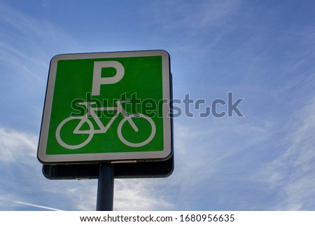 Parking bicycle green city park sign on blue sky background