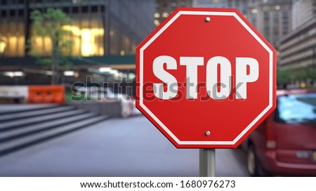 A stop word written on a stop sign at the street background