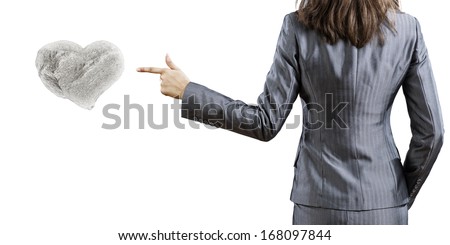 Businesswoman pointing with finger at huge stone