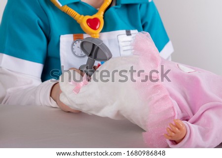 little girl playing to be a nurse
