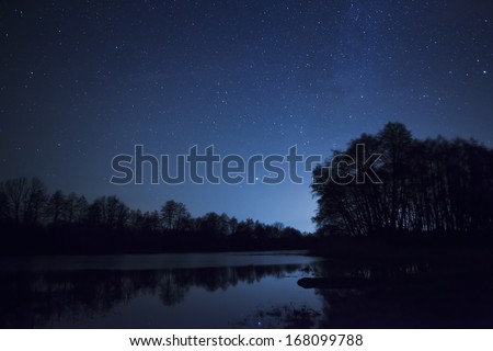 a beautiful night sky, the Milky Way and the trees Royalty-Free Stock Photo #168099788