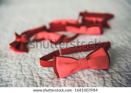A lot of red wedding men's bow ties. Groom's neck tie. Accessories for groom's friends