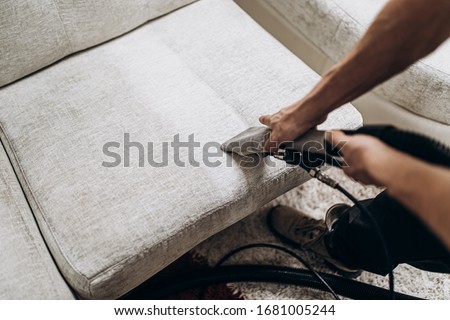 Process of deep furniture cleaning, removing dirt from sofa. Washing concept. Royalty-Free Stock Photo #1681005244