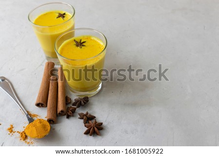 Turmeric latte, golden milk with turmeric honey and cinnamon, alternative medicine, Indian drink to enhance immunity, protection against coronavirus