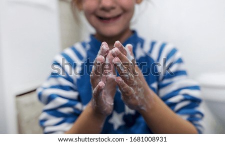 little girl, washing her hands, for the prevention of covid-19 infection, in the bathroom
