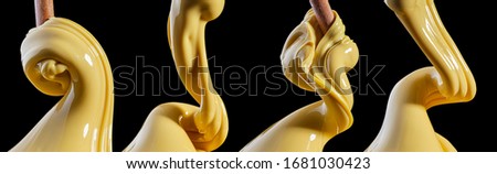 Viscous thick yellow liquid flows close-up isolated on black background Royalty-Free Stock Photo #1681030423