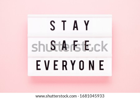 STAY SAFE EVERYONE written in light box on pink background. Healthcare and medical concept. Top view. Quarantine concept. Royalty-Free Stock Photo #1681045933