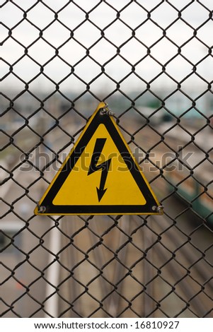 electricity danger sign on steel grid
