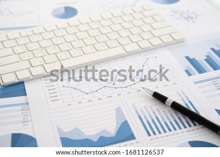 Pen on financial report with keyboard on desk of financial adviser. Concept of invest planning, analyze return on investment. Royalty-Free Stock Photo #1681126537