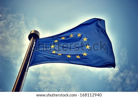 European Union flag on blue sky background Royalty-Free Stock Photo #168112940