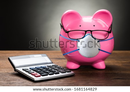 Piggybank With Face Mask During Coronavirus Recession Royalty-Free Stock Photo #1681164829